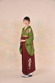 緑の着物に赤の袴を着た女性