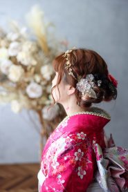カチューシャタイプの髪飾りにレースの花飾りを差したヘアスタイル